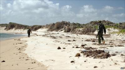 Armed police patrol a stretch of beach near Kiwayu Safari village, where British couple David and Judith Tebbutt were attacked