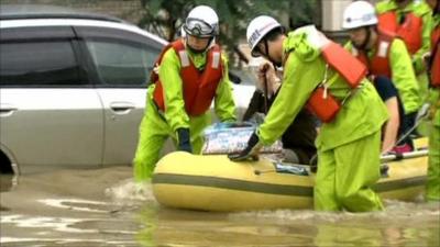 Rescuers help evacuate people