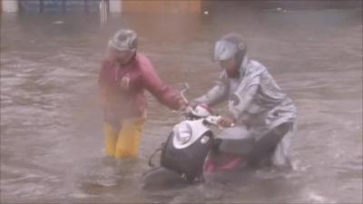 People struggling to make it through flood waters