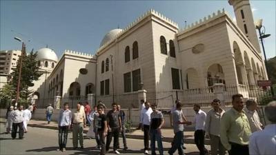 People on the streets outside a mosque in Damascus