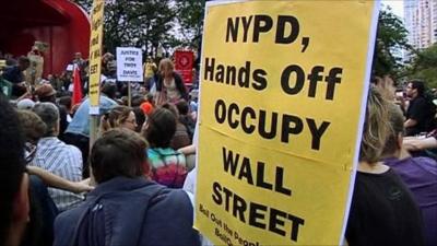 Protesters holding placards at Occupy Wall Street demonstration