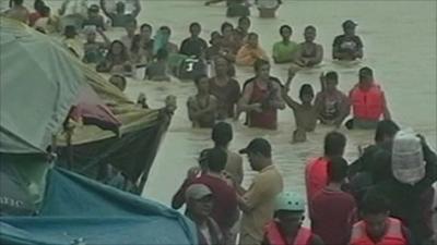 People wade through water in Philippines