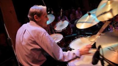 Levon Helm playing drums