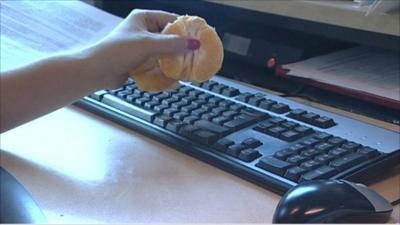 Eating an orange over a keyboard