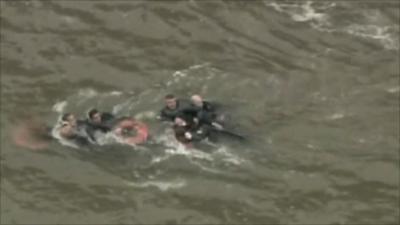 Helicopter passengers being rescued