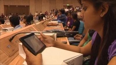 A student holds India's news tablet computer