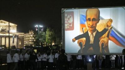 Members of a pro-Kremlin youth movement gather in front of a screen to wish PM Vladimir Putin a happy birthday