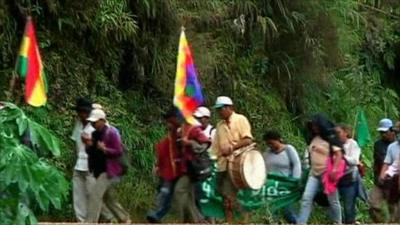 Protesters walk along mountain roads