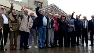 People celebrating outside the Scottish Parliament