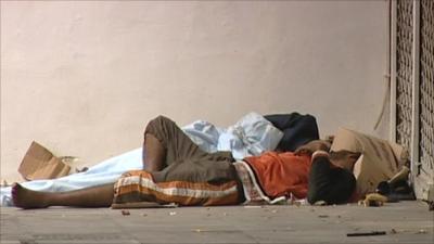 Two homeless people sleeping on an Athens street