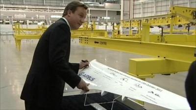 David Cameron signing a model wing