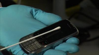 A phone being swabbed