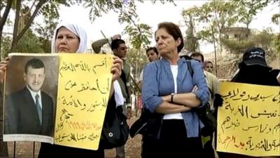 Jordanian women hold banners at sit-in