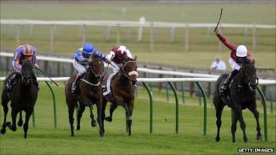 Richard Hughes riding Crius (r) at Newmarket racecourse in September