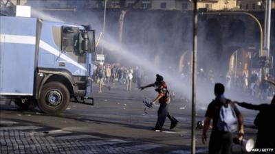 Rioter throws missile at water cannon truck