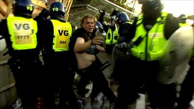 Riot police and a protester at Dale Farm