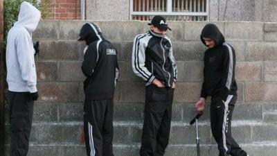 Young boys playing truant hiding their faces