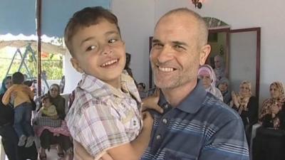 Former Palestinian prisoner holding a child