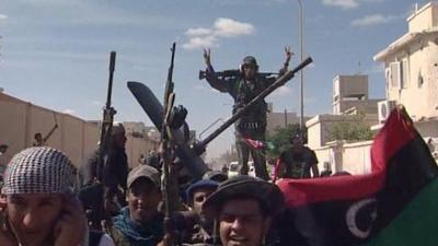 Libyan fighters in Sirte celebrate reports that Gaddafi is dead