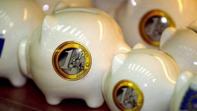 Piggy banks with picture of euro coin on side