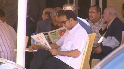 People read papers in cafe in Tunisia