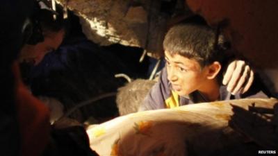 13 year old boy waiting to be rescued from rubble