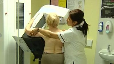 Nurse helping woman through screening