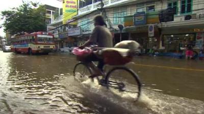 A cyclist on a flooded Bangkok street