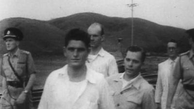 Three former POWs return