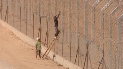 Workers constructing the fence