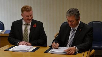 Guernsey Airport contract signed by Public Services Minister Bernard Flouquet and Lagan's managing director Colin Loughran