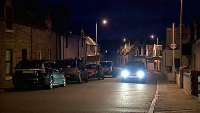 Cars on a street at night