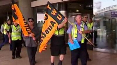 Union members walk with flags