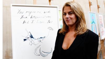 Tracey Emin poses with her poster