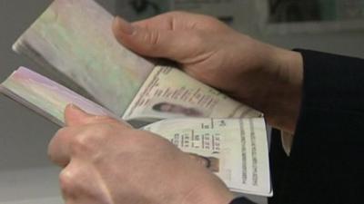 Man holding two passports