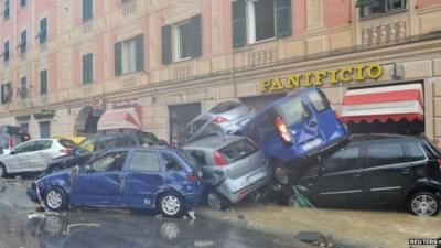 Cars piled high after flood