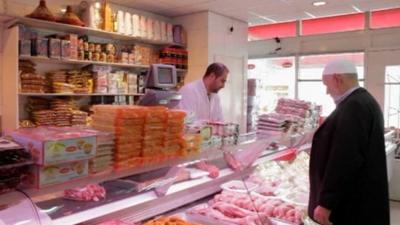 Halal butcher serving customer