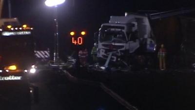 Damaged front of truck with recovery vehicles alongside