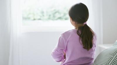 Girl sitting on a bed