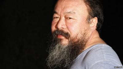 Dissident Chinese artist Ai Weiwei stands at the entrance of his studio after being released on bail in Beijing June 23, 2011