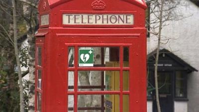 Red telephone box with a defibrillator sign