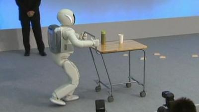 Asimo the robot pushes drinks trolley