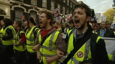 Protesters link arms and march