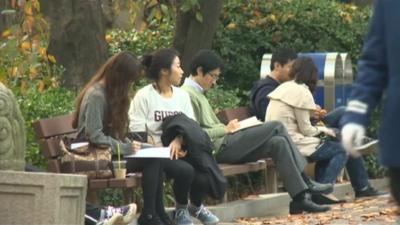 Students seated on a bench