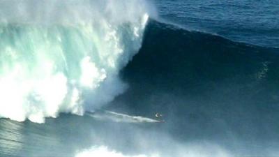 Surfer rides gigantic wave