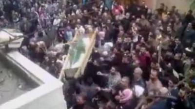 Protesters carrying coffin in Homs, Syria