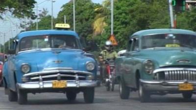 Classic cars being driven in Cuba
