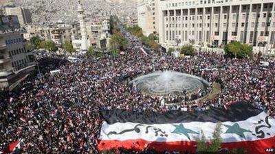 Thousands attend a rally in support of Syrian President Bashar al-Assad in Damascus, 13 November