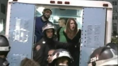 Woman shouting from a police van