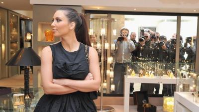 Kim Kardashian flanked by cameras